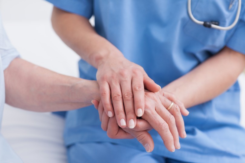 Provider holding patient's hand Provider holding patient's hand