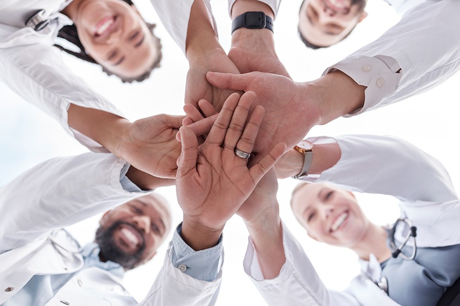 Medical professionals touching hands